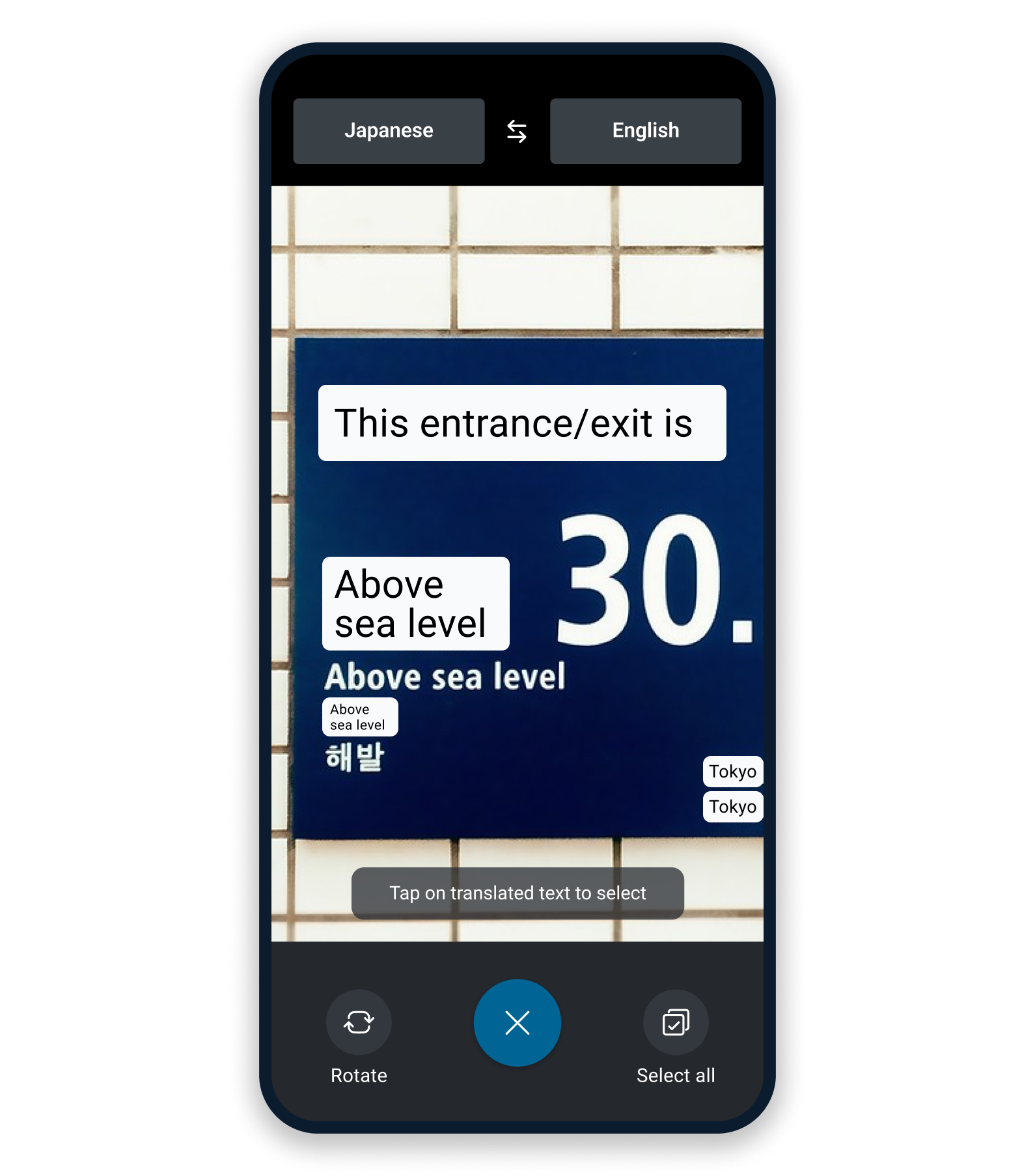 Smartphone showing the DeepL app’s camera feature to translate a road sign from Japanese into English